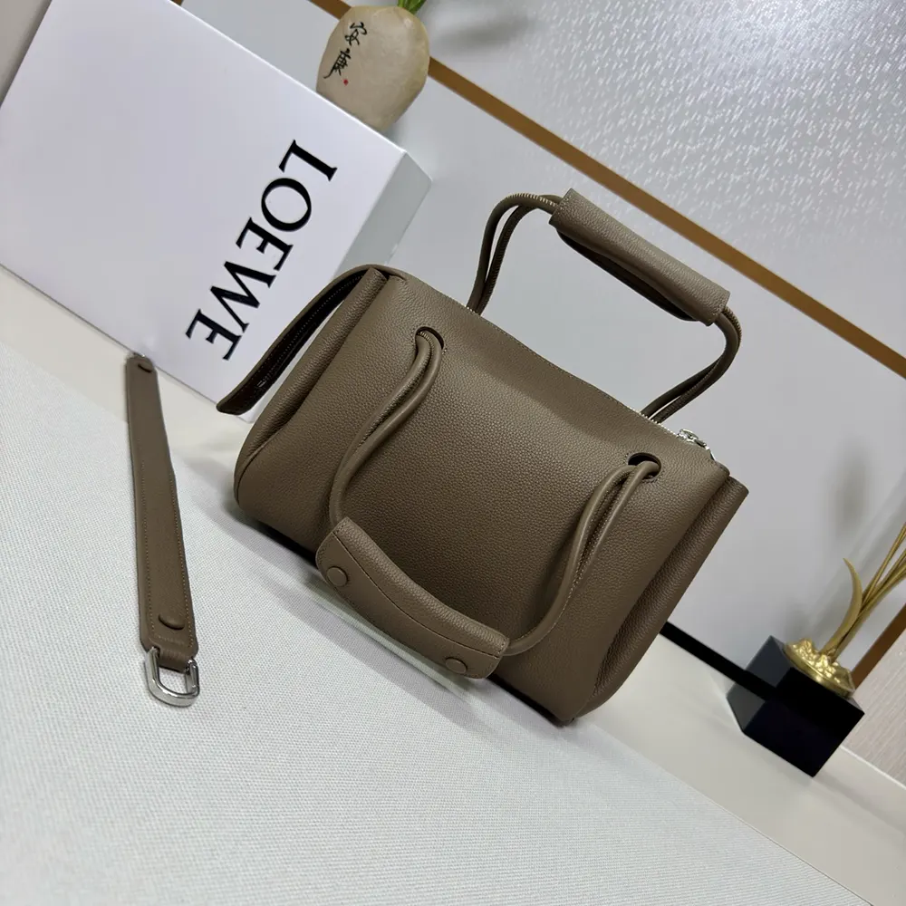 Close-up of gray leather texture and silver hardware on Small Madrid Bag
