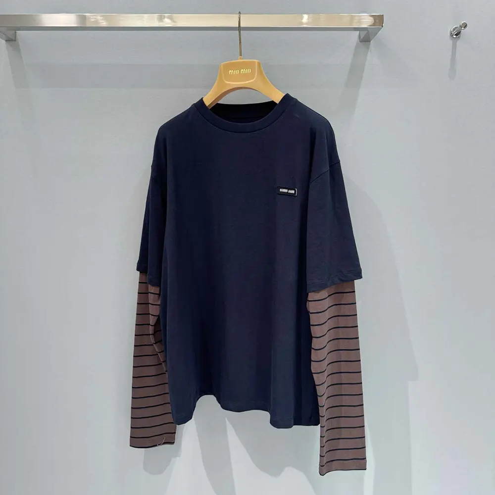 Close-up of black jersey fabric and stitching on Miu Miu T-shirt