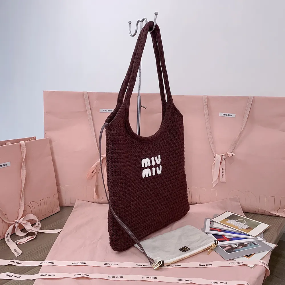 Side angle showing spacious interior and leather trim of Miu Miu woven tote