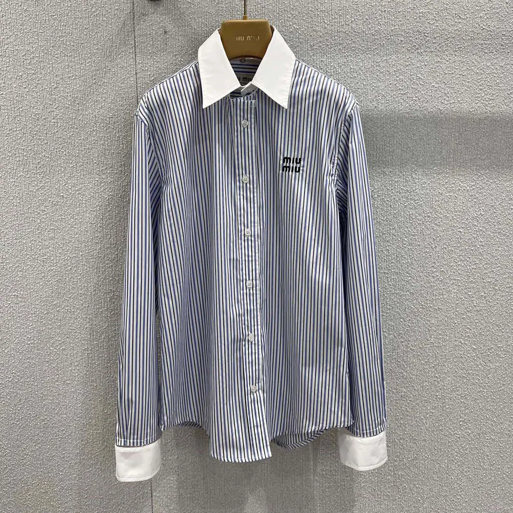 Close-up of Miu Miu tonal buttons on striped poplin shirt