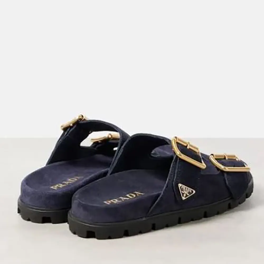 Overhead shot showing navy suede and sleek silhouette of Prada slides