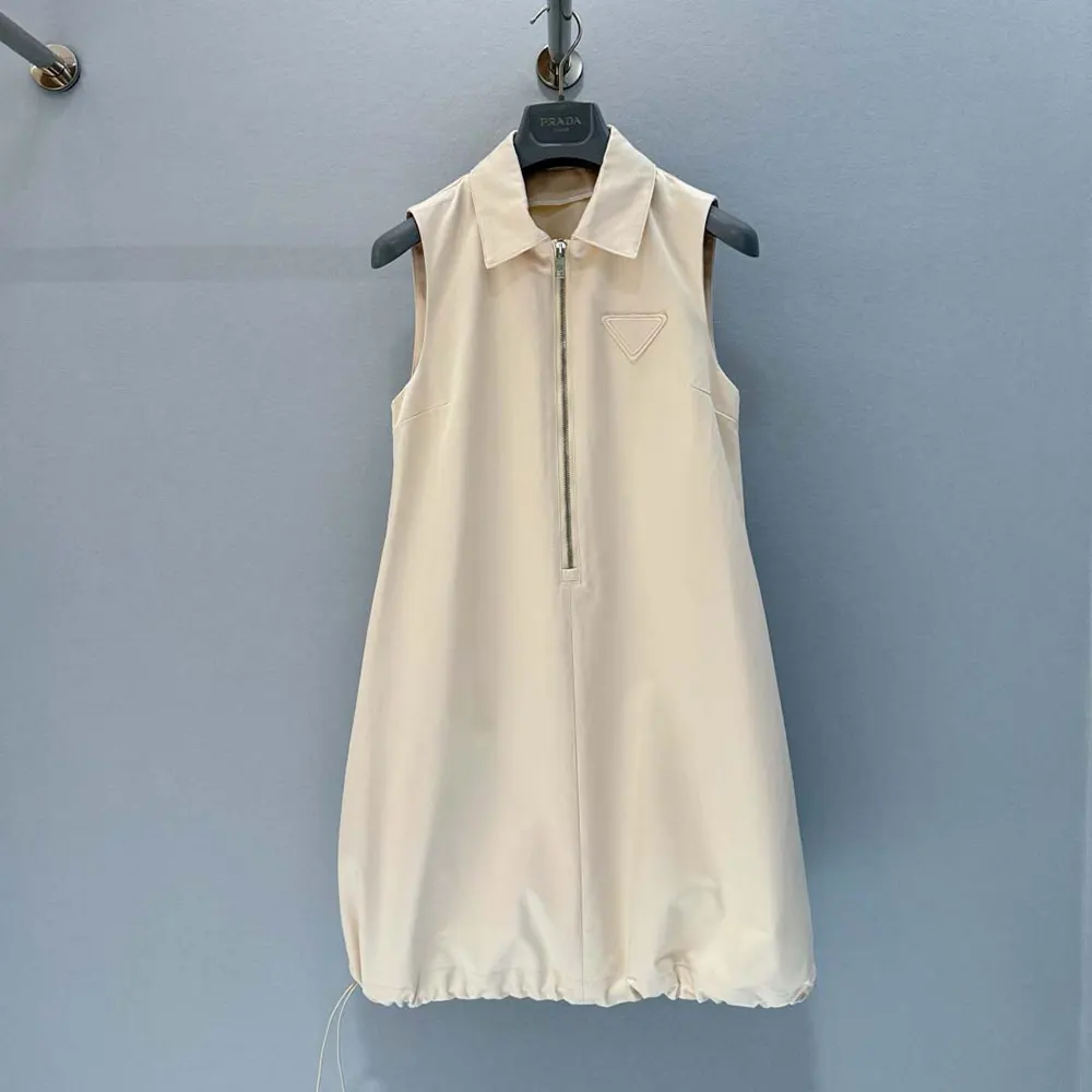 Close-up detail of Prada logo hardware on mini-dress zipper