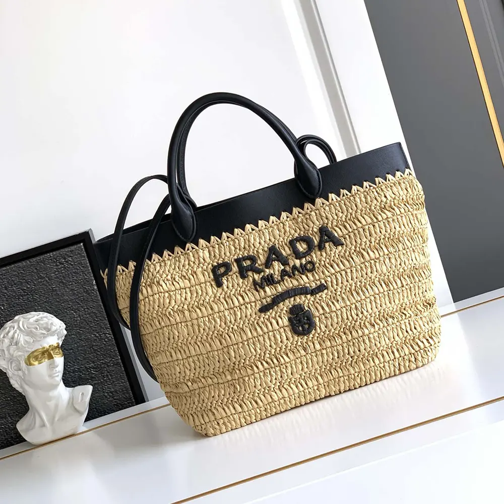 Close-up on silver Prada logo and crochet detail of tote bag