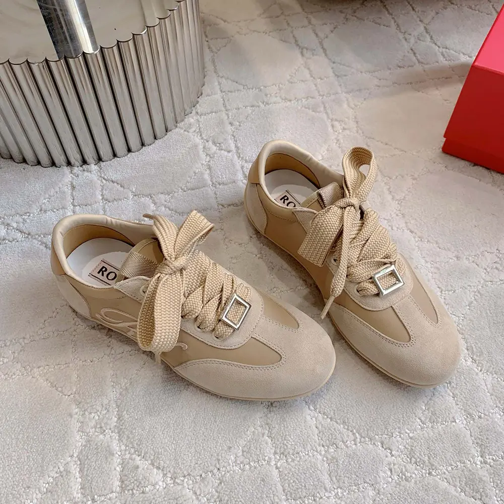 Close-up of metallic buckle detail on Viv Low Sneakers beige suede