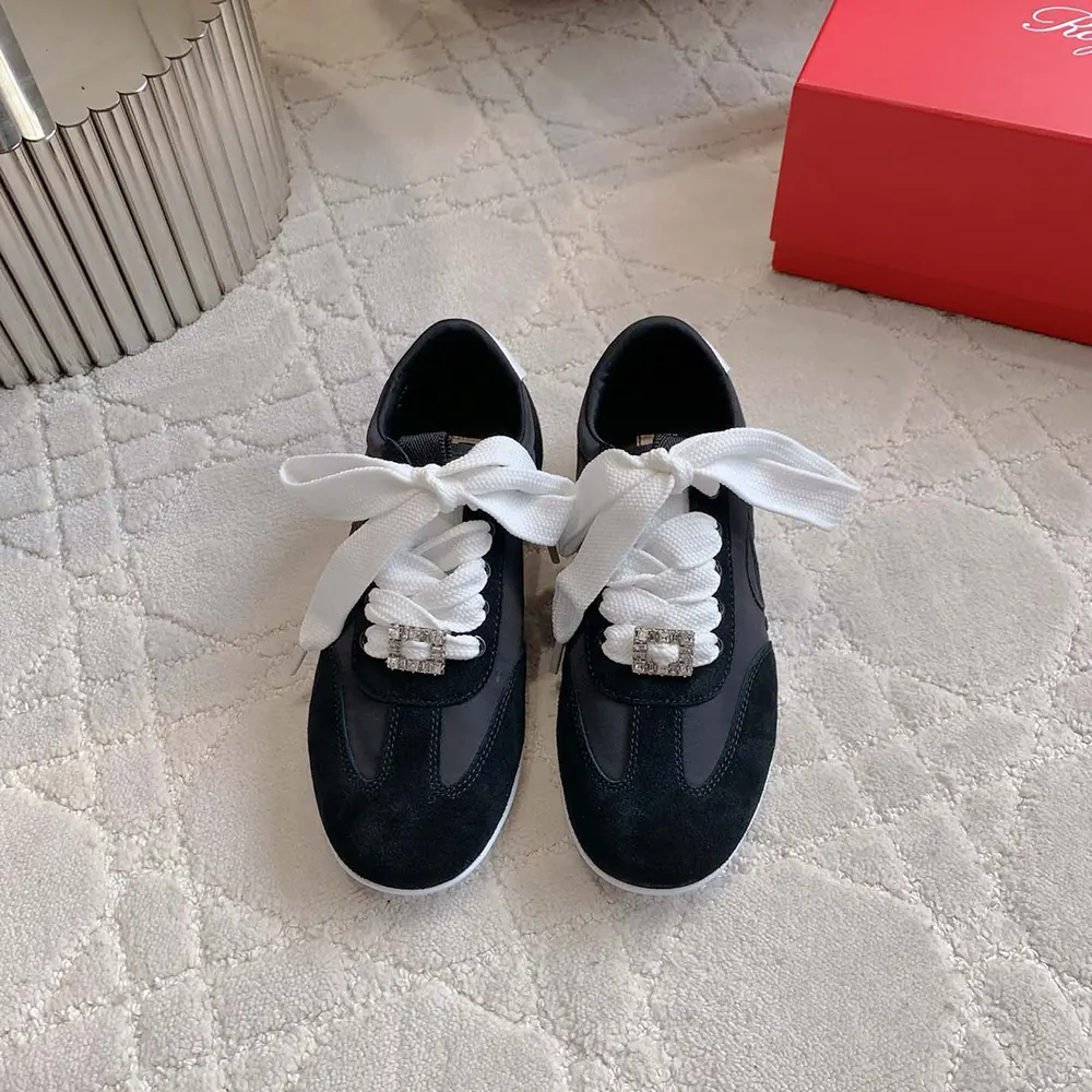 Close-up of silver buckle detail on Roger Vivier Women Viv Low Sneakers