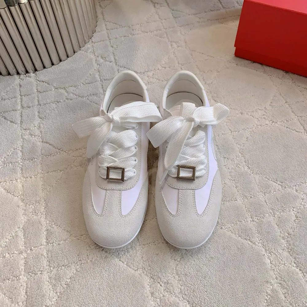 Close-up of signature buckle on Roger Vivier Women Viv Low Sneakers