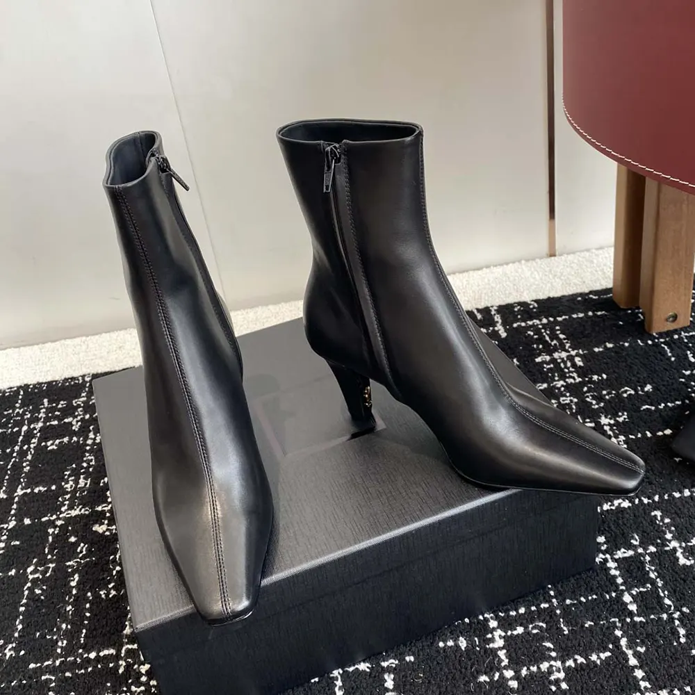 Top view showing pointed toe and smooth leather texture booties