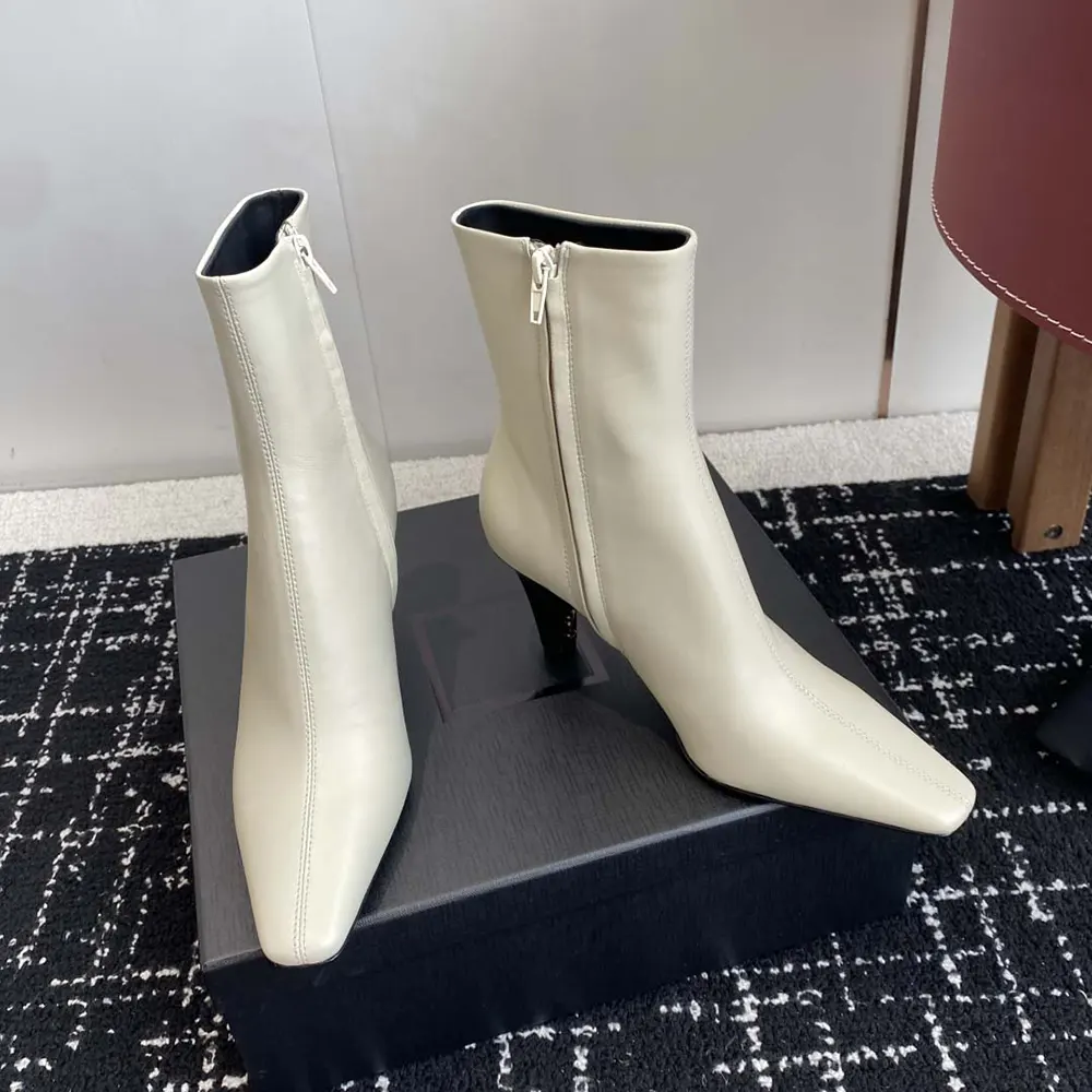 Three-quarter view showing smooth leather and zipper detail on Jill Booties