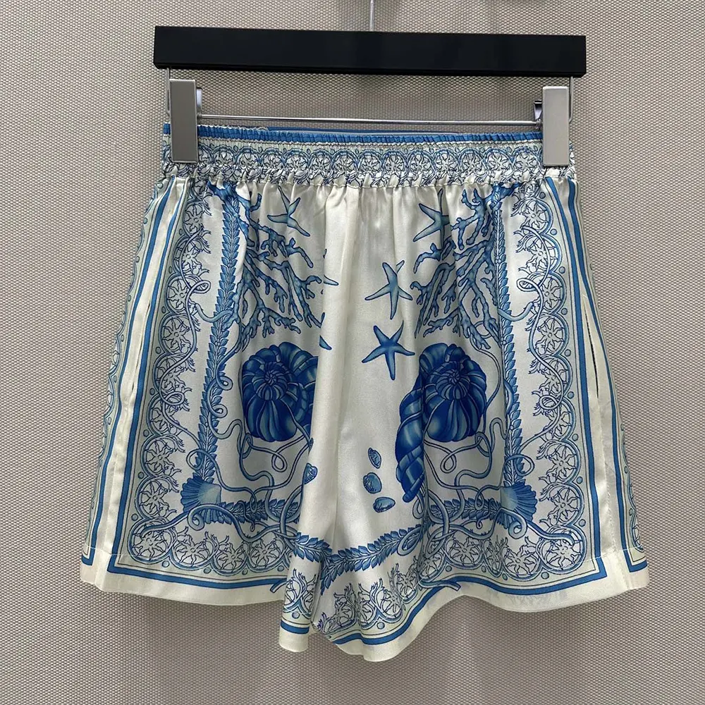 Side angle highlighting vibrant blue Barocco print on Versace Women Underwater Barocco Cotton Shorts-Blue
