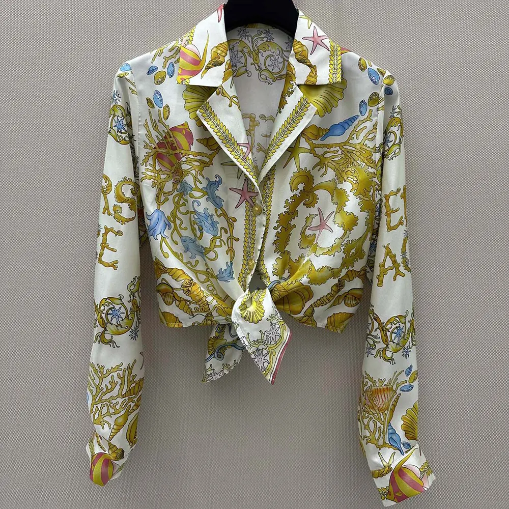 Close-up of Barocco print and knotted detail on Versace silk shirt