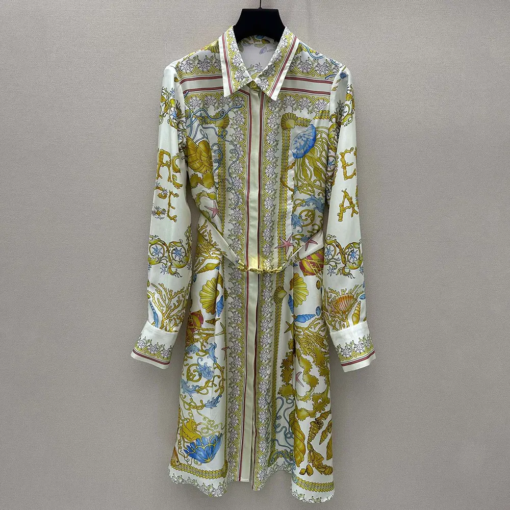 Close-up of gold Barocco buttons on Versace silk midi shirt dress