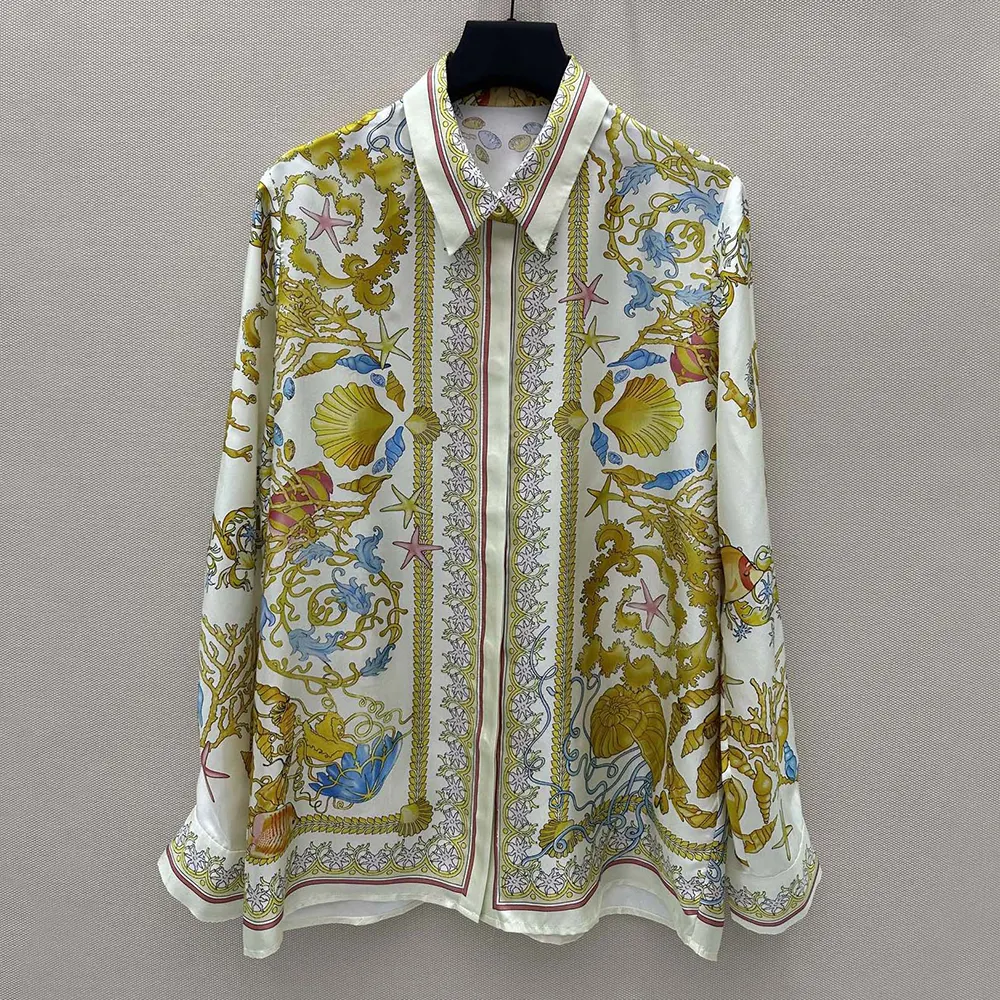 Close-up of yellow silk and Barocco print on Versace Women shirt