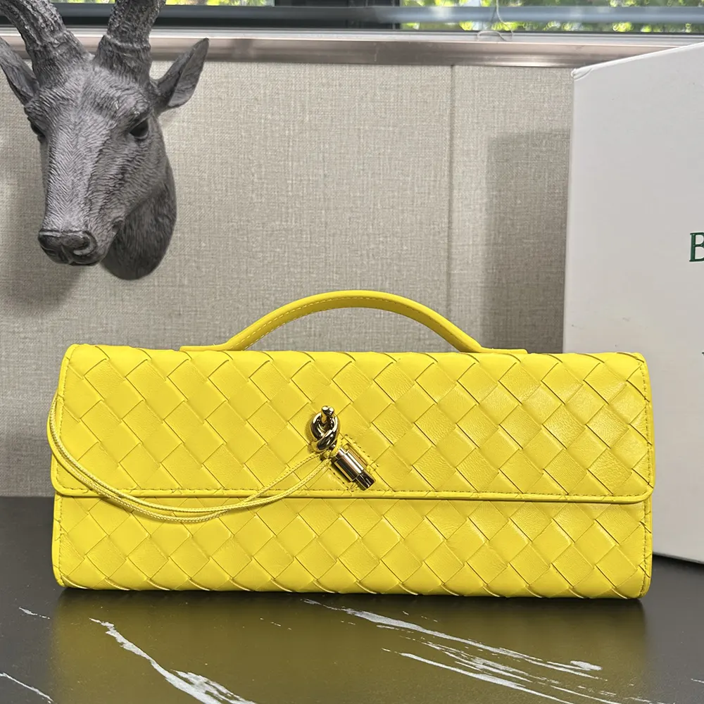 Close-up of signature Intrecciato woven leather detail on Andiamo Clutch