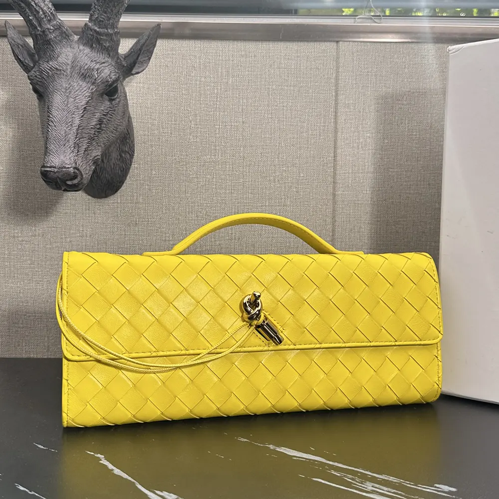 Side angle showing gold-tone hardware on Bottega Veneta Andiamo Clutch