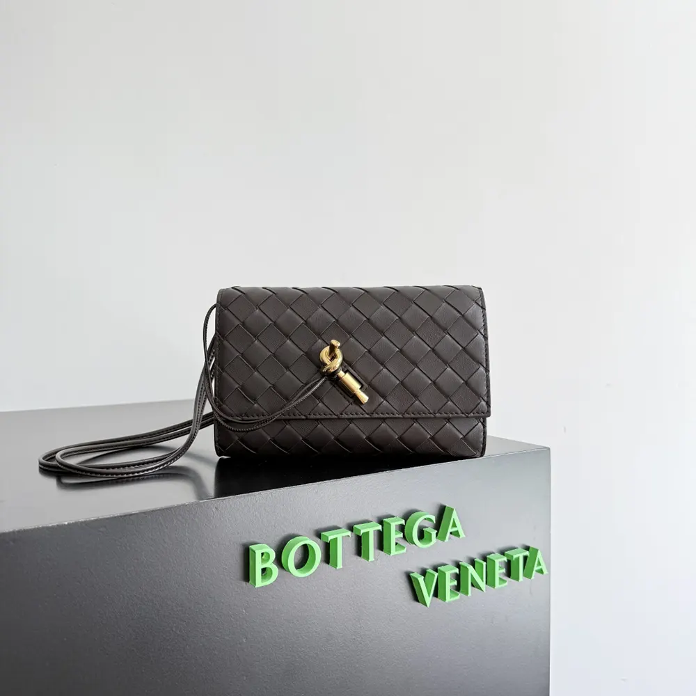 Side angle highlighting the pouch’s smooth nappa leather and gold hardware