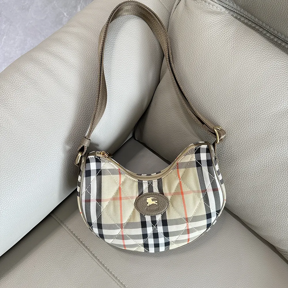 Close-up of gold-tone horseshoe closure on Burberry Women Horseshoe Crossbody Bag