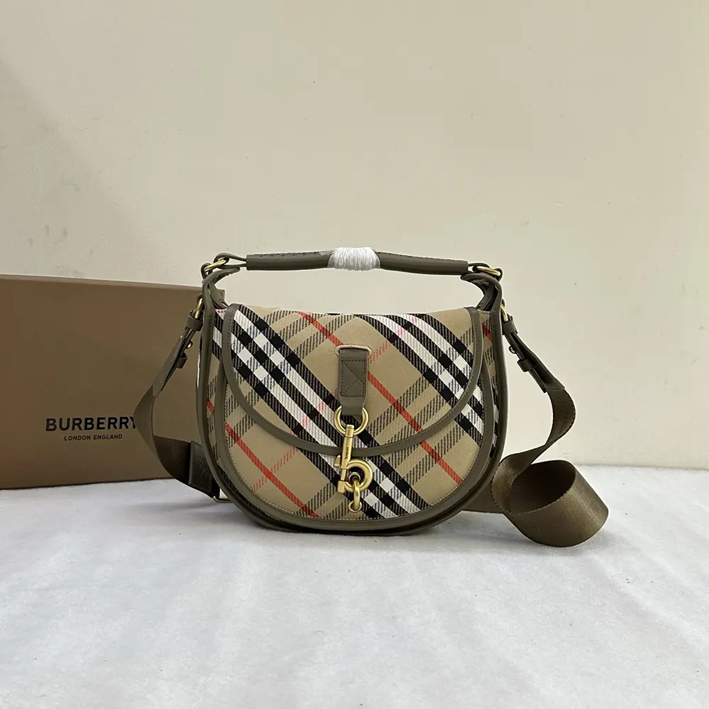 Close-up of gold-tone B Clip closure on Burberry messenger bag