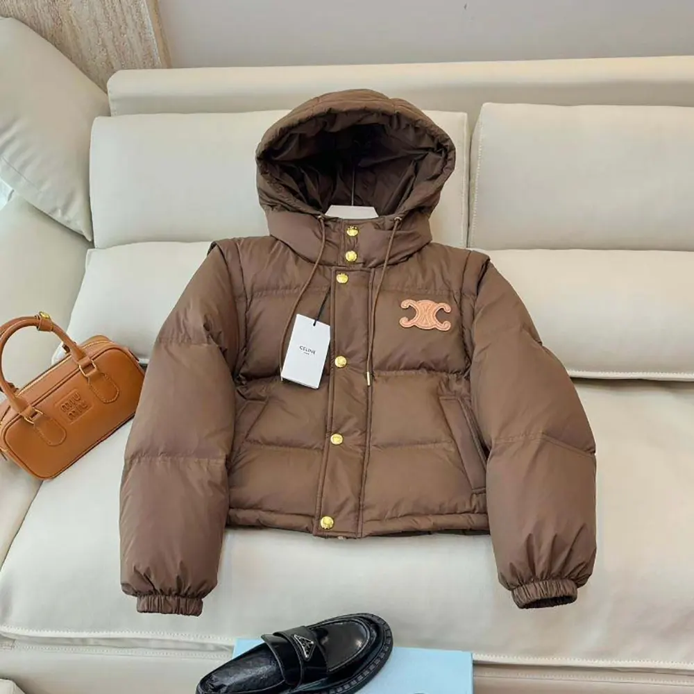 Close-up detail of Triomphe zipper pull on Celine down jacket
