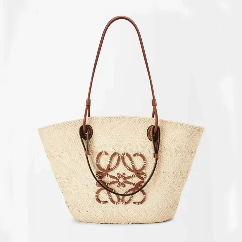 Front angled view of Loewe Women Large Anagram Basket Bag in Iraca Palm