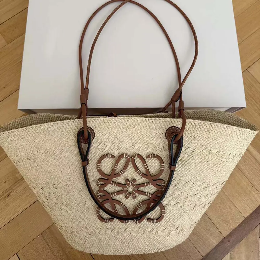 Side profile showing natural weave and calfskin strap on Loewe basket bag