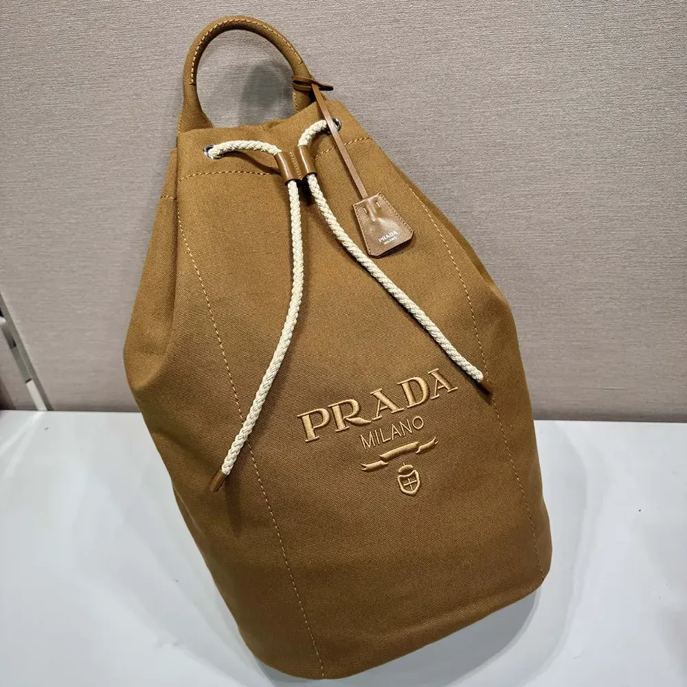 Close-up of drawstring and antique gold hardware on Prada bag
