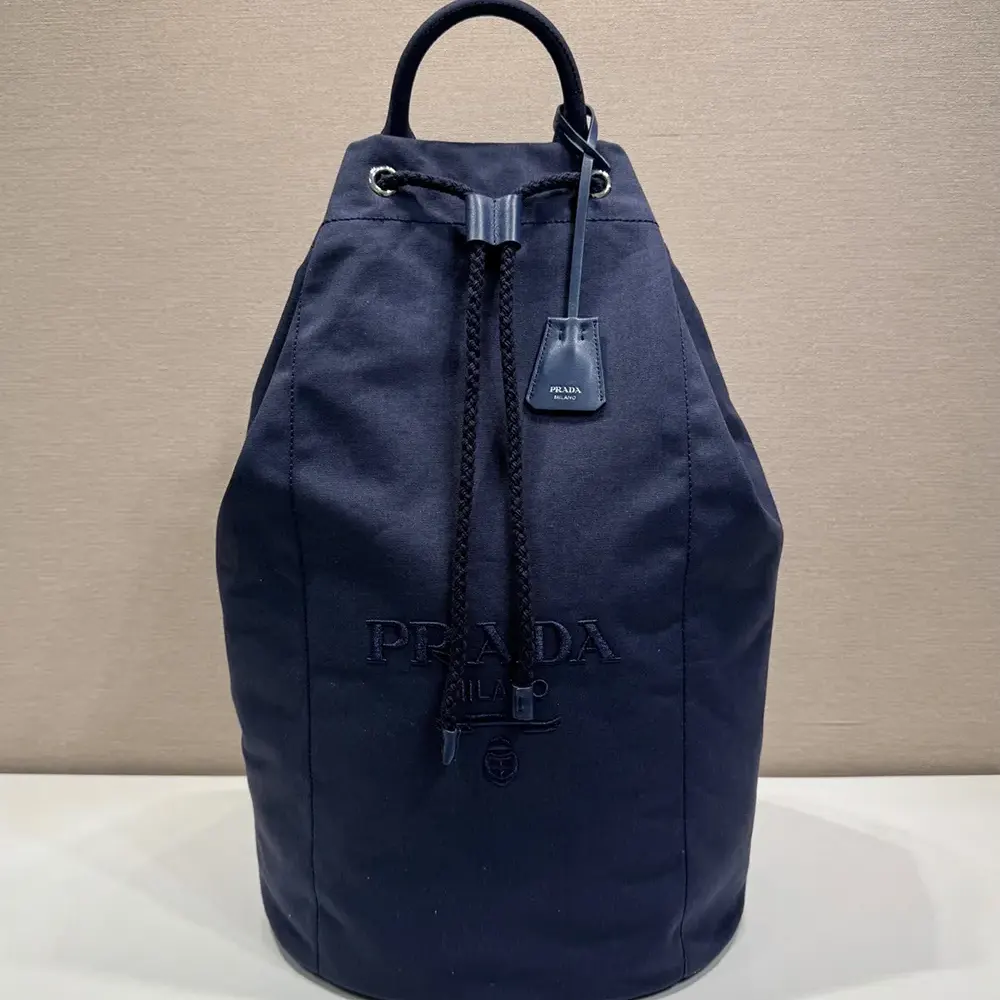Close-up of brushed silver-tone hardware on Prada Unisex Canvas Drawstring Duffle Bag-Navy
