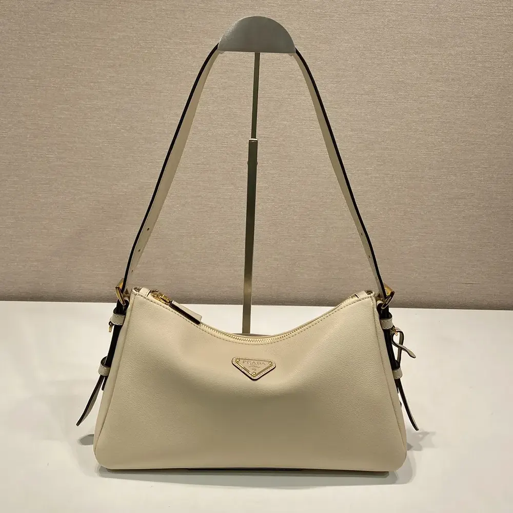 Close-up on gold-tone hardware of Prada Women Aimée Medium Leather Shoulder Bag-Sandy