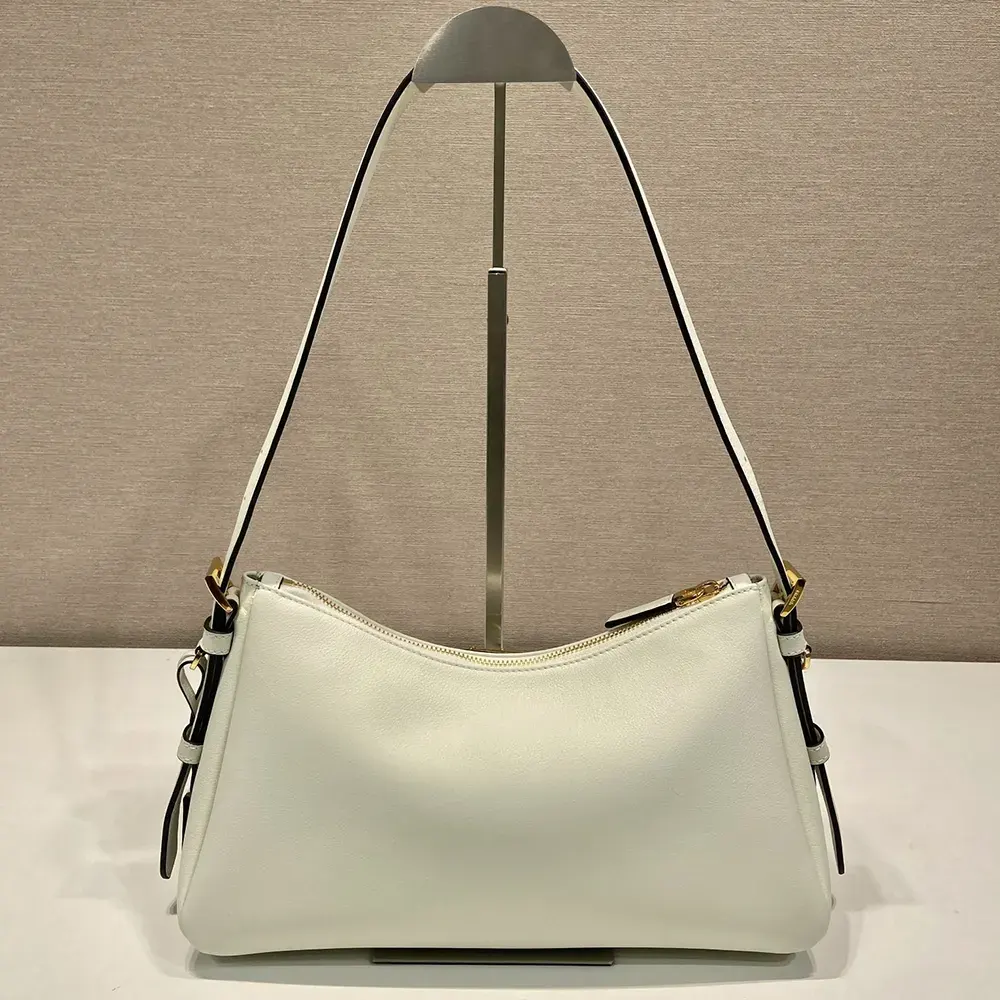 Side angle showing structured silhouette of Prada Women Aimée Medium Leather Shoulder Bag-White