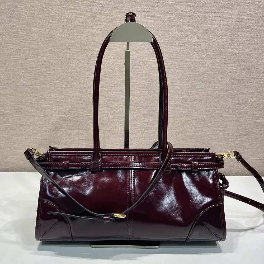 Side angle showing silhouette and shoulder strap of Prada Women Bonnie Medium Handbag