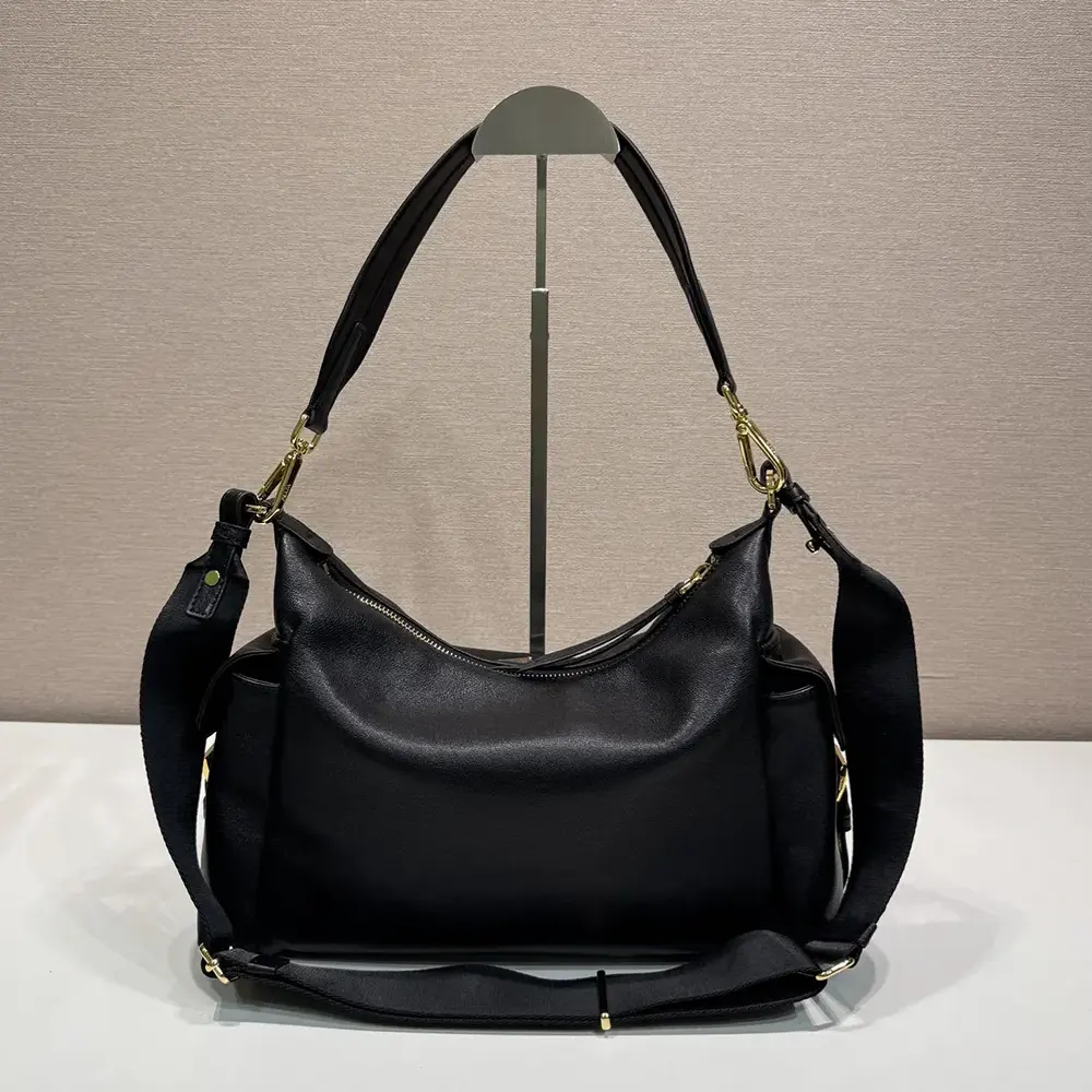 Side angle showing silhouette and strap detail of Prada Women Explore bag