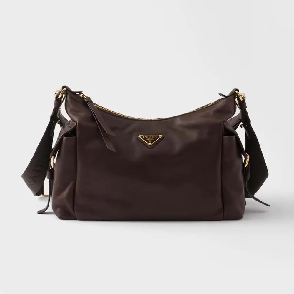 Front angle of Prada Women Explore Large Nappa Leather Bag-Dark Brown showing zip closure