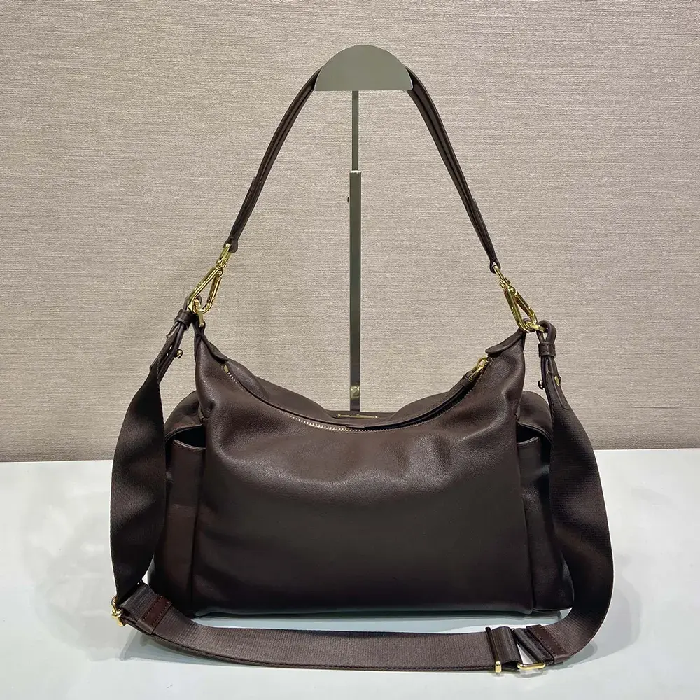 Side view highlighting spacious silhouette of Prada Women Explore Large Nappa Leather Bag-Dark Brown