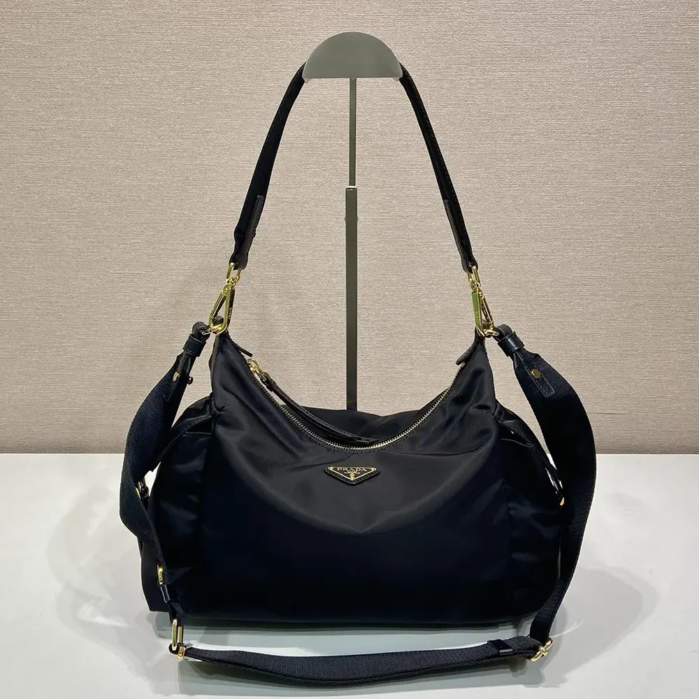 Close-up of silver-tone hardware on Prada Women Explore Large Re-Nylon And Leather Bag-Black