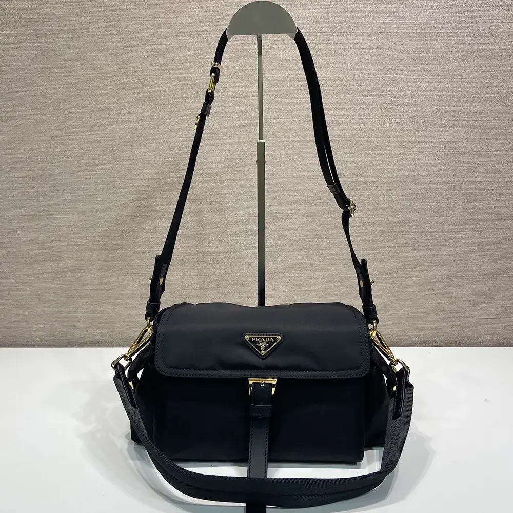 Close-up on flap and polished hardware of Prada Women Explore Large Re-Nylon Shoulder Bag