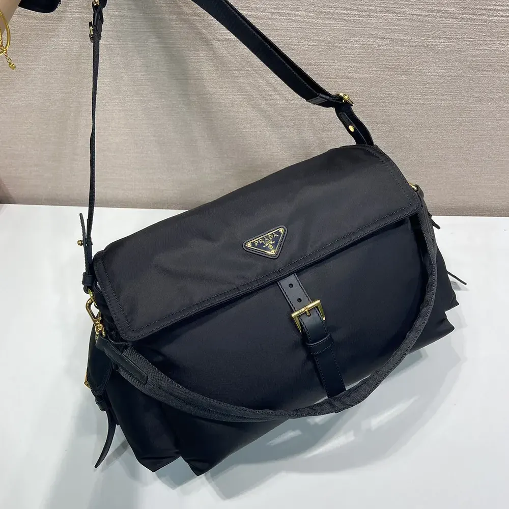 Side angle showcasing adjustable strap and flap closure of Prada Women Explore bag