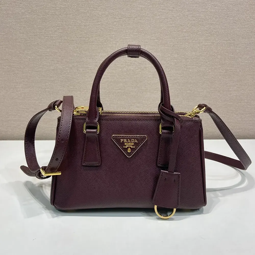 Close-up of saffiano leather texture and gold Prada logo on Galleria Mini bag