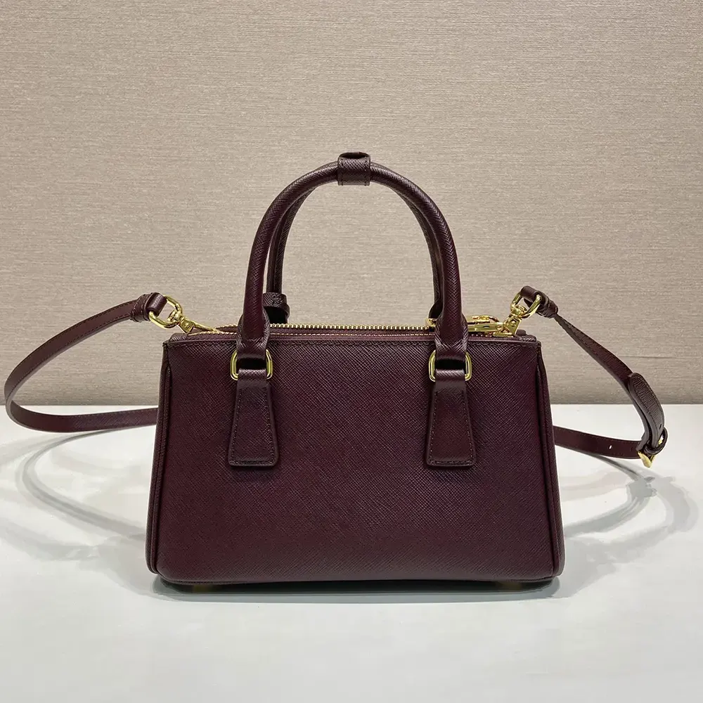 Side angle showing zipper closure and shoulder strap of Prada Galleria Mini bag