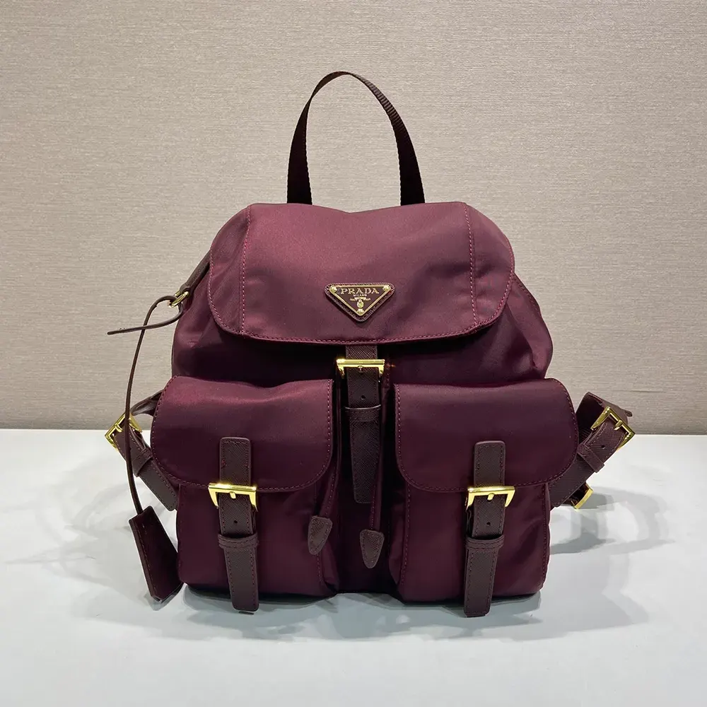 Close-up of silver Prada triangle logo on Re-Nylon backpack