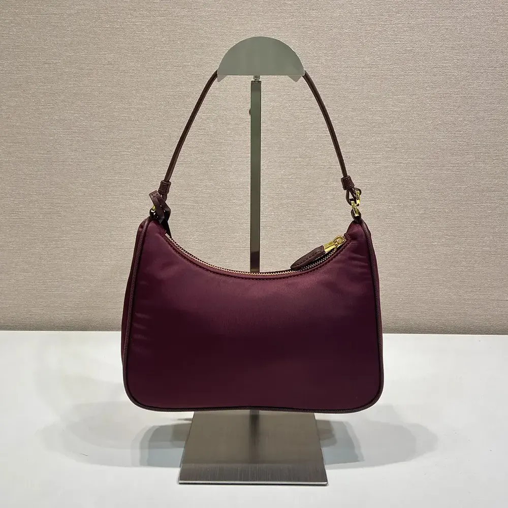 Side angle showing the zip closure and leather trim of the Prada Mini Bag