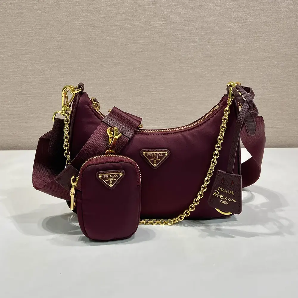 Close-up of silver triangle logo on Prada Women Re-Edition 2005 Re-Nylon Bag