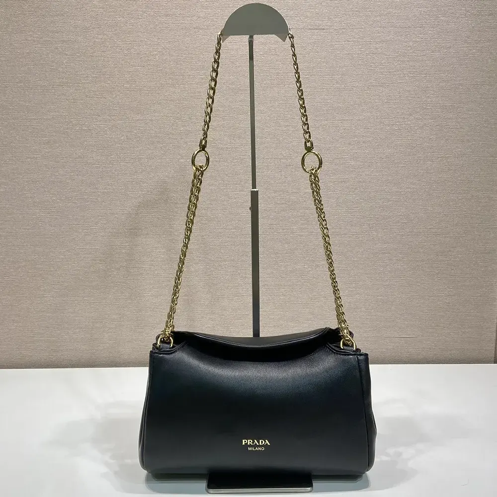 Close-up of leather texture and silver hardware on Prada Women Tumulte Small Nappa Leather Bag-Black