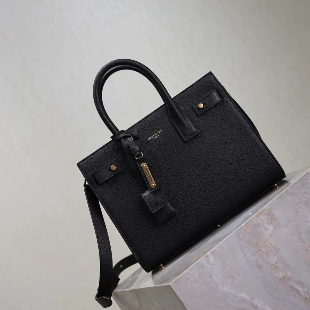 Side angle showing silhouette and zipper of Baby Sac De Jour black bag