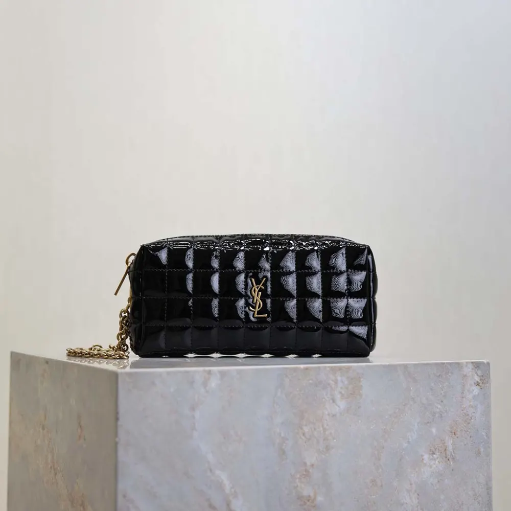 Close-up of gold YSL logo and quilted matelassé detail on pouch