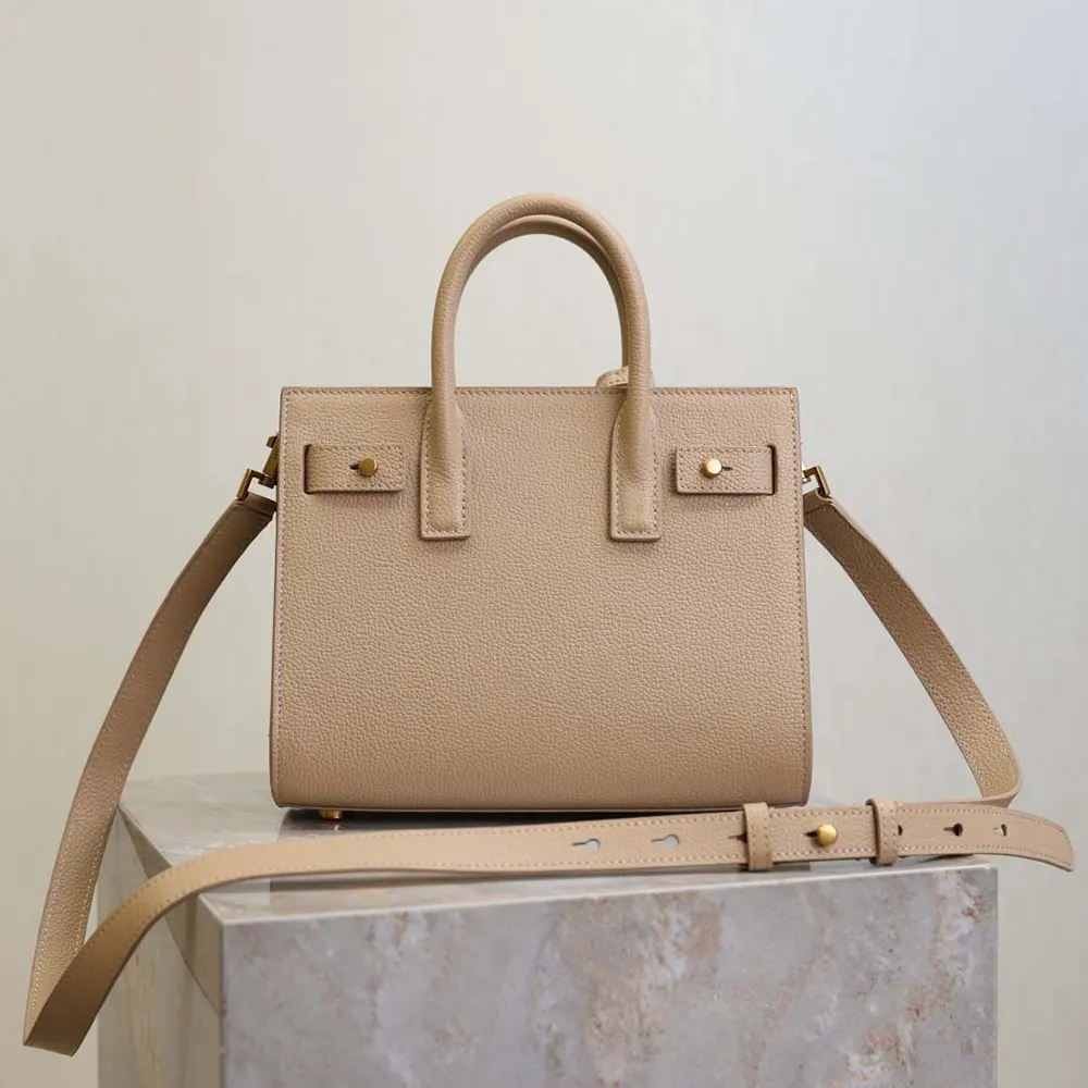 Side angle showing structured silhouette of Saint Laurent YSL Nano Sac De Jour beige