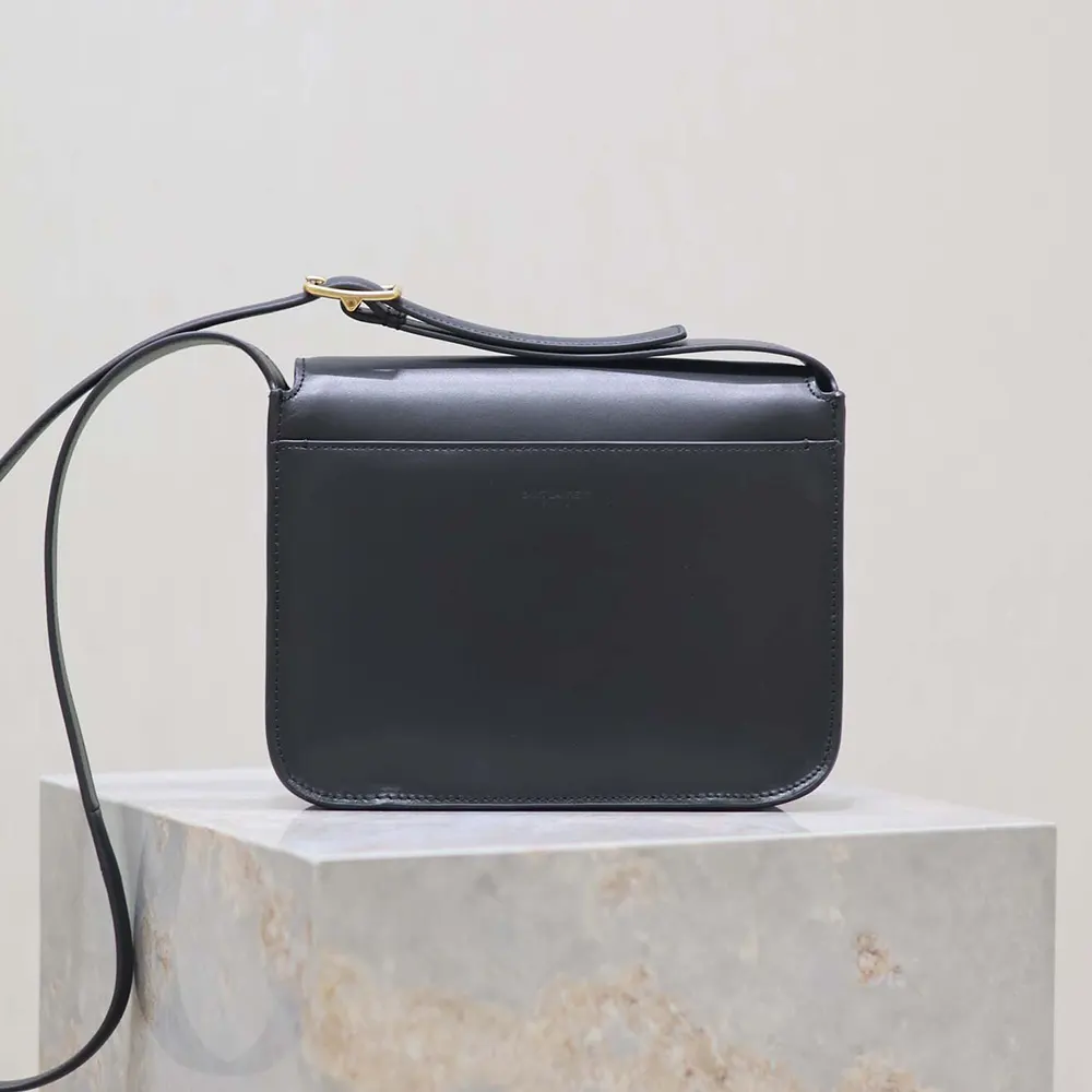 Side profile of black leather Saint Laurent YSL Women Niki Satchel with shoulder strap