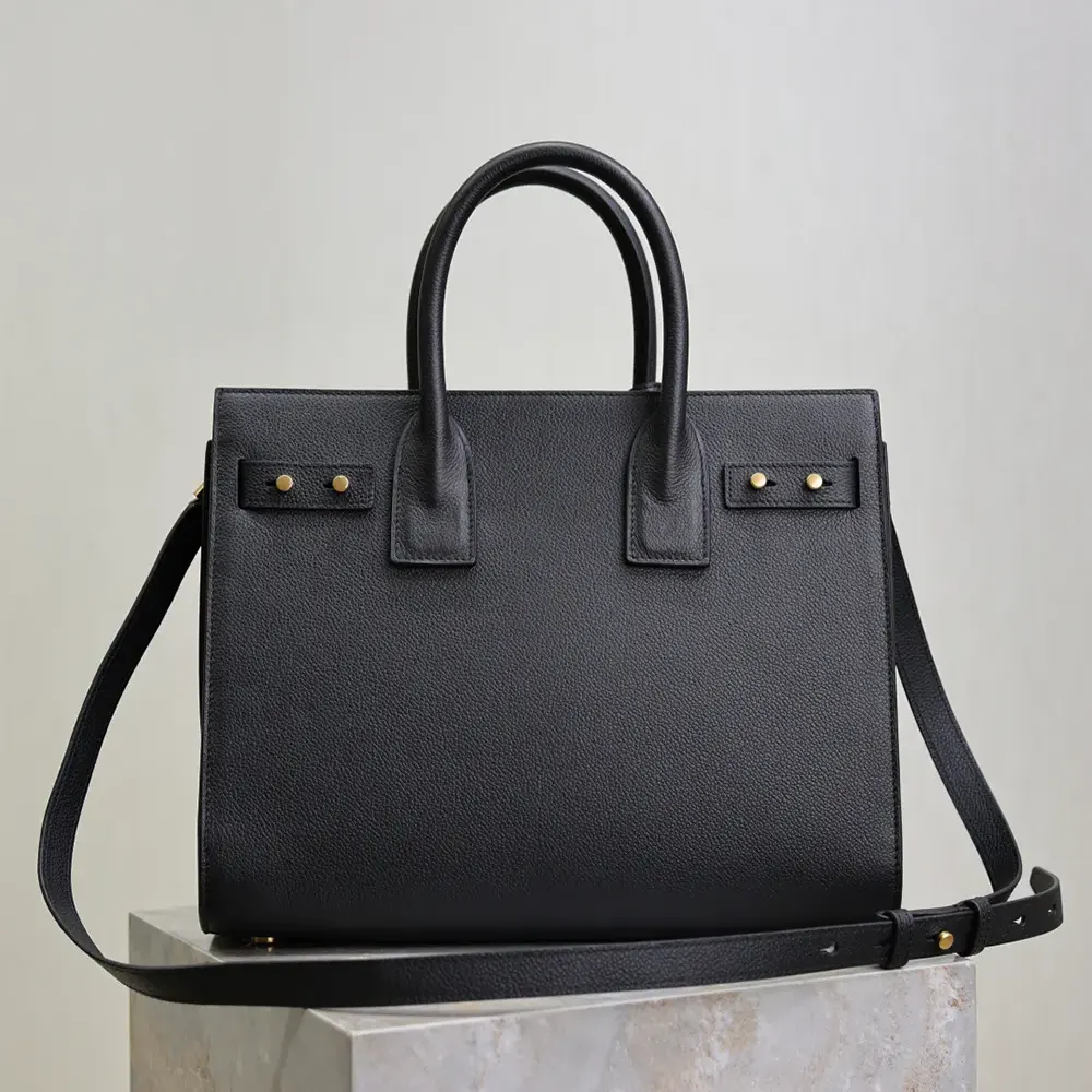 Side angle showing the zip closure and leather texture on Saint Laurent YSL shoulder bag