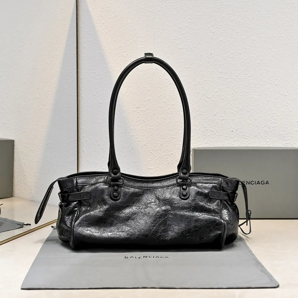 Side angle showing strap and buckle of Balenciaga Women Le City Bag East-West In Black