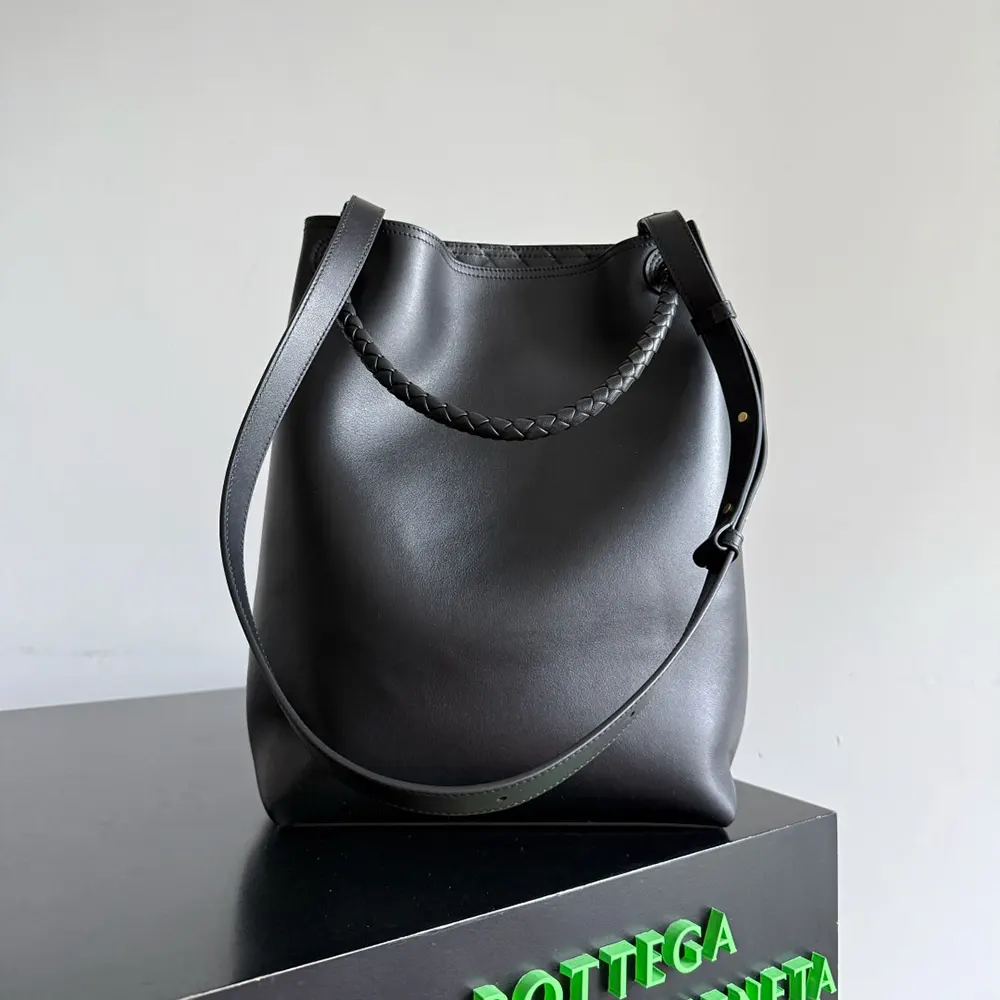 Side profile showing bucket shape of Bottega Veneta Women Andiamo Bucket black handbag
