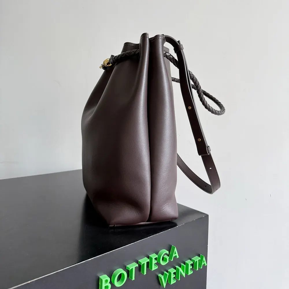 Side angle showing drawstring closure on Bottega Veneta Andiamo Bucket
