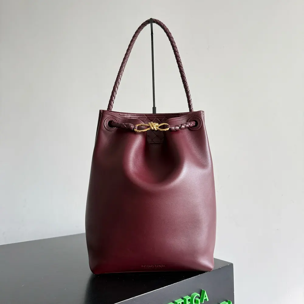 Close-up detail of drawstring closure on Women Andiamo Bucket maroon leather